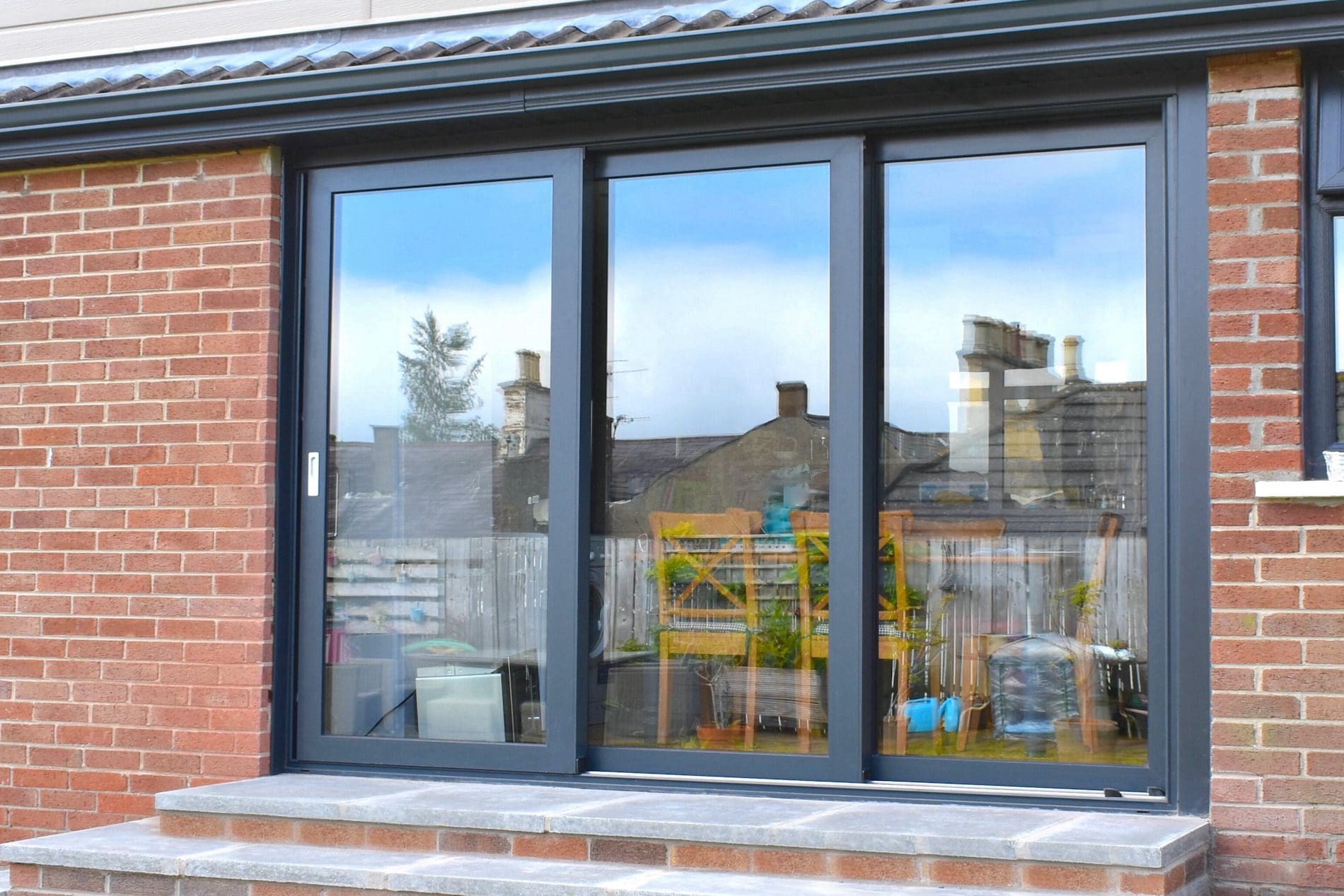 Triple track patio door in grey