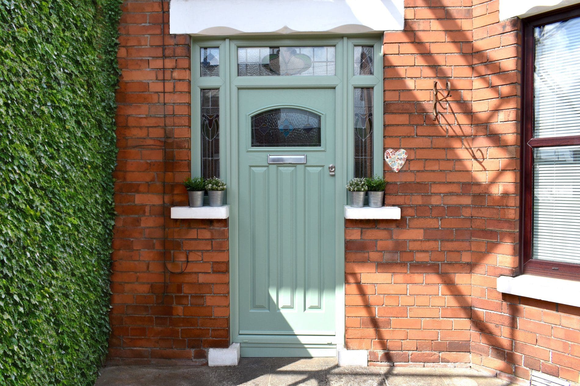 Stained glass retention in a new composite front door